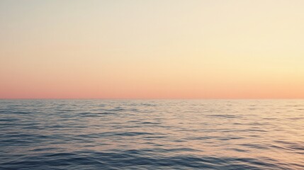 Obraz premium A serene ocean view at sunset with pale blush tones creating a calming backdrop of water and sky