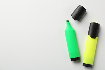 Bright highlighters on white background, flat lay. Space for text