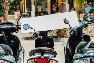 Blank sign on parked scooters in a vibrant street scene. Perfect for RENT, travel, transportation, or advertising concepts/