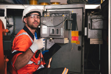 Caucasian male technician inspecting and repairing a robotic arm in a high tech industrial manufacturing factory, highlighting automation, engineering expertise, and advanced machinery.