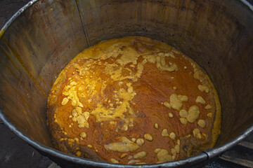 Villager making palm oil in Dokoue, Benin