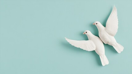 Two White Birds Flying Against a Soft Blue Background
