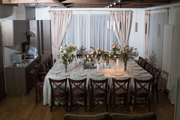 Decorative elements for festive events, home decorations. Festive table decorations, flowers and tableware