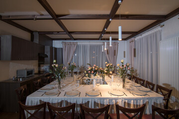 Decorative elements for festive events, home decorations. Festive table decorations, flowers and tableware