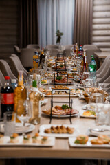 Elegant Dining Table Set for a Gathered Feast with Various Dishes and Beverages