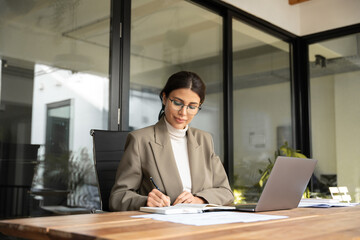 Middle-age Latin Hispanic woman using laptop computer for business studying, watching online...
