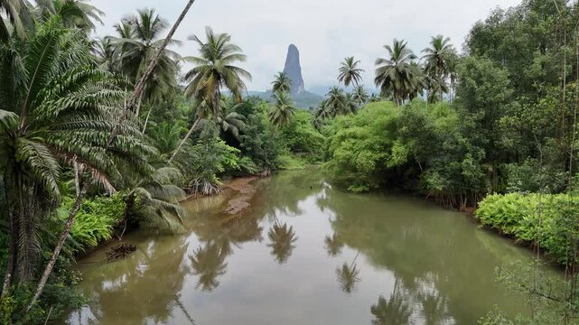 Sao Tome and Principe - River and Tropical Forest With Pico Cao Grande. Scenic Jungle Landscape Reflected in Calm Water.