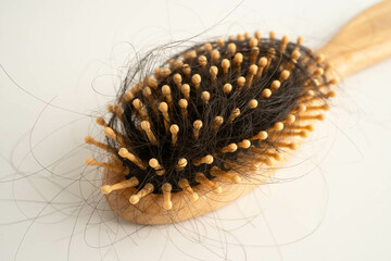 Hair loss fall with comb brush isolated on white background.