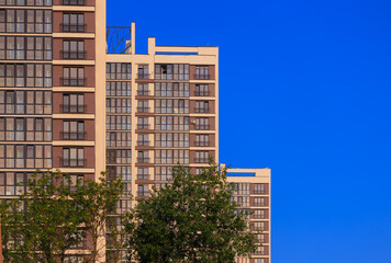 Fototapeta premium City view on a sunny day. Modern buildings, walls and windows. 