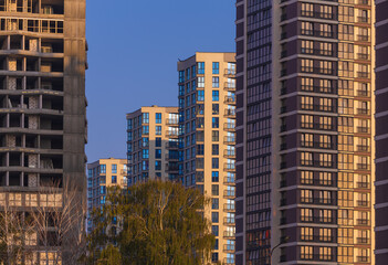 Fototapeta premium City view on a sunny day. Modern buildings, walls and windows. 