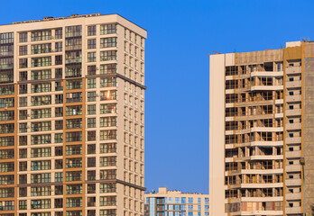 City view on a sunny day. Modern buildings, walls and windows. 