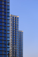 Obraz premium City view, modern buildings and skyscrapers against the blue sky.