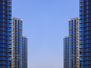 Obraz premium City view on a sunny day. Modern buildings, walls and windows. 