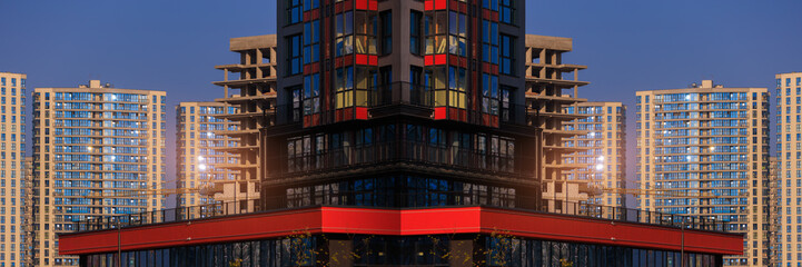Obraz premium Modern buildings, walls and windows, reflections and sun rays. City view on a sunny day. 