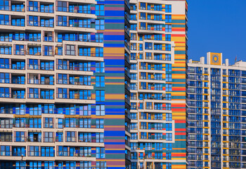 City view on a sunny day. Modern buildings, walls and windows. 