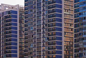 City view on a sunny day. Modern buildings, walls and windows. 