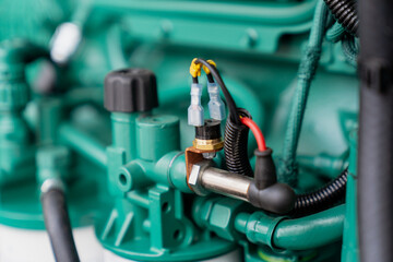Engine electric wires close up. Electric engine components close up of wiring. Rare metal wiring for electrical wires in generator engine, covered by protective electric membrane