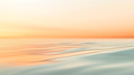 Obraz premium A soft apricot-colored mist covering a calm mountain landscape at dawn.