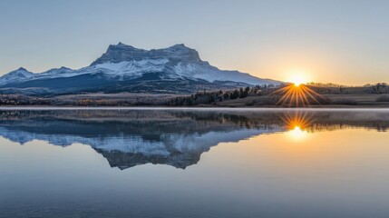 Serene Sunrise Over Snowy Mountain Reflected in Calm Lake Water