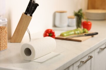 Roll of paper towels on white marble countertop in kitchen