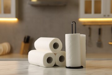 Rolls of paper towels on white marble table in kitchen