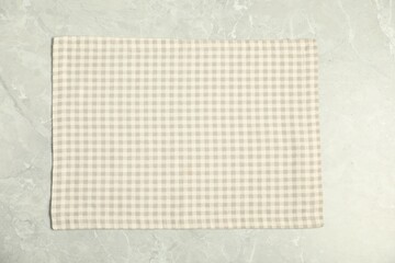 Checkered napkin on grey marble table, top view