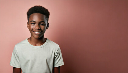 Obraz premium Portrait of a Smiling Young Schoolboy with a Happy Expression Against a Pastel Background