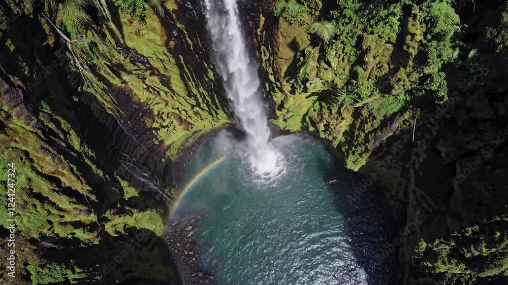 Poster Majestic waterfall cascading into serene pool surrounded by lush greenery in a remote location