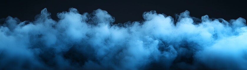 Naklejka premium Mysterious blue smoke in a dark backdrop.