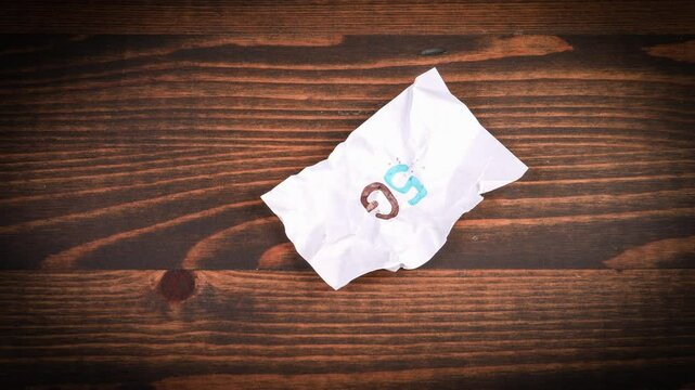 5G. Crumpled paper straightens and appears word. Stop motion, 4K