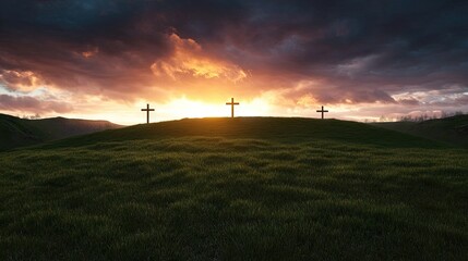 Obraz premium Three wooden crosses stand on a grassy hill under a dramatic sunset with colorful clouds in the background