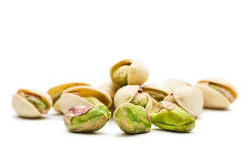 Pistachio nuts close up, isolated on white background.