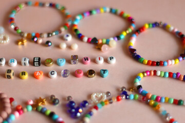 Friendship bracelet spelled with letter beads. Colorful handmade bracelets and various beads....
