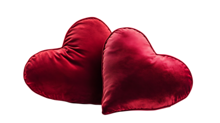 Two red heart-shaped pillows placed together against a white background.