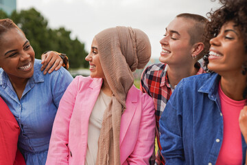 Group of young multiracial women having fun together in the city - Girls from diverse cultures and...