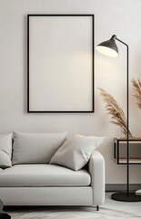 A modern living room with a light grey sofa, a black floor lamp, and a shelf on the right side of a picture frame. The poster frame on the wall is blank. 