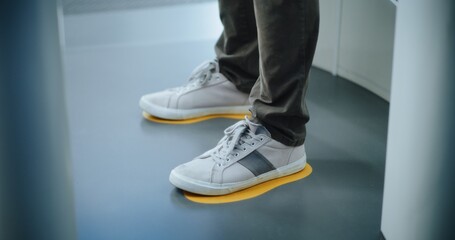 Security Checkpoint in Airport Terminal: Knee Level Shot of Unrecognizable People Standing in X-ray...