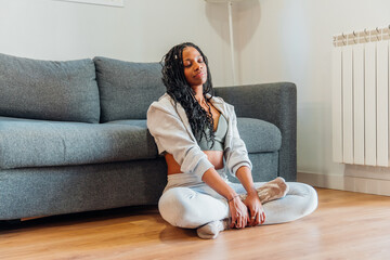 Young woman relaxing at home after yoga practice