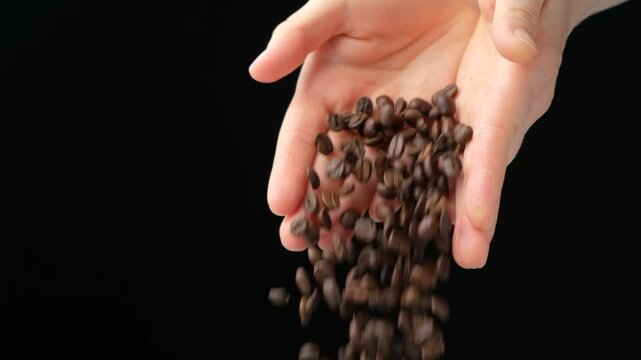 Hands Pouring Decaffeinated Coffee Beans Black Background Slow Motion.