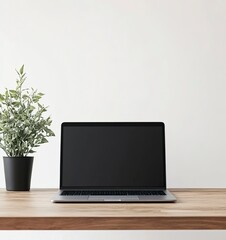 Fototapeta premium Laptop mockup on a wooden table with a plant, against a white background, in a minimalist style, studio photography, stock photo.