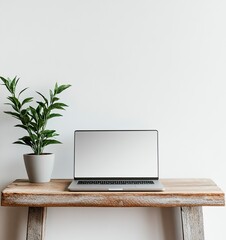 Fototapeta premium Laptop mockup on a wooden table with a plant, against a white background, in a minimalist style, studio photography, stock photo.
