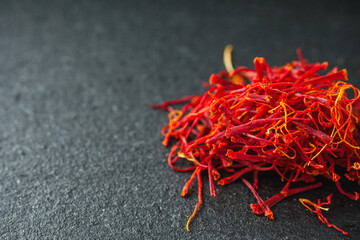 fragrant expensive spice saffron on a dark stone background