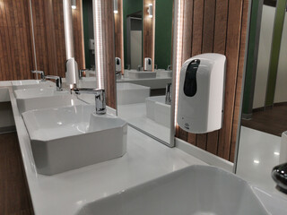 Automatic liquid soap dispenser in public toilet