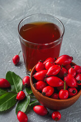 fresh red rosehip tea on a stone background