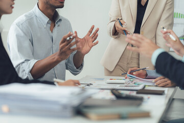 Collaboration and Strategy: A diverse team of professionals engages in a passionate discussion...