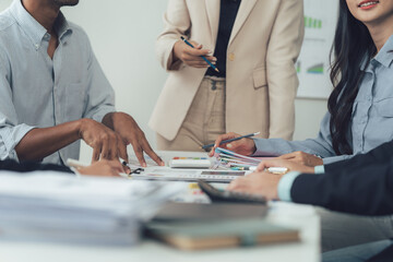 Collaborative Business Meeting: A diverse team of professionals engaged in a focused discussion...