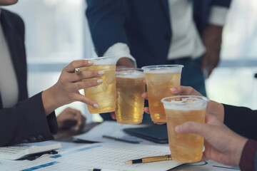 Cheers to Success: Four colleagues clink glasses of beer in celebration of a successful project, fostering camaraderie and a sense of accomplishment.  