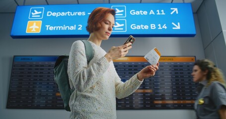 Airport Terminal: Happy Female Passenger Scanning Plane Ticket or Taking Picture Using Phone, Going...