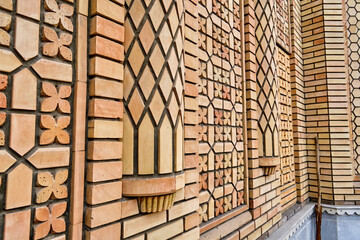Facade of the mosque with unique brickwork, beautiful eastern decoration, and unique decoration with polished bricks