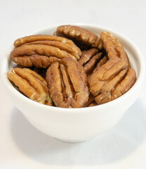 Pecan nuts in white bow close up